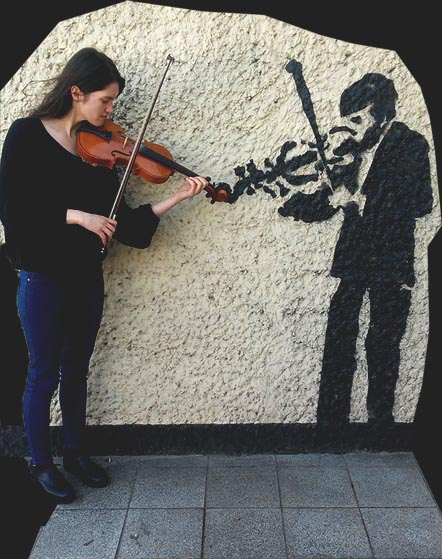 Emilia Malińska przy muralu przedstawiającym skrzypka